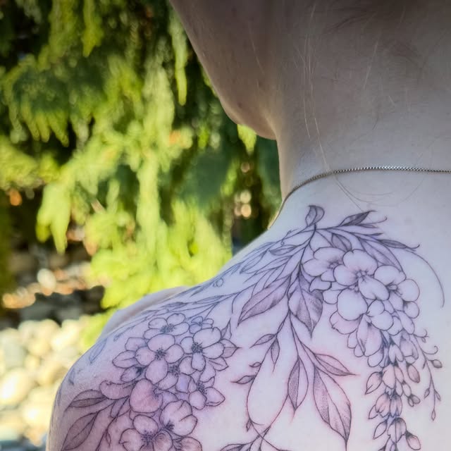 Fine-line wisteria and florals across the shoulder