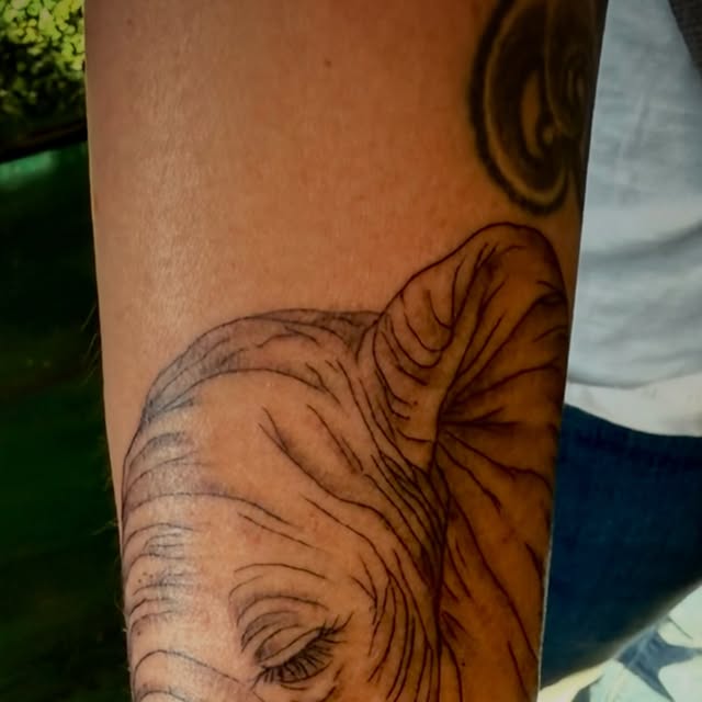 Black and grey elephant on the forearm