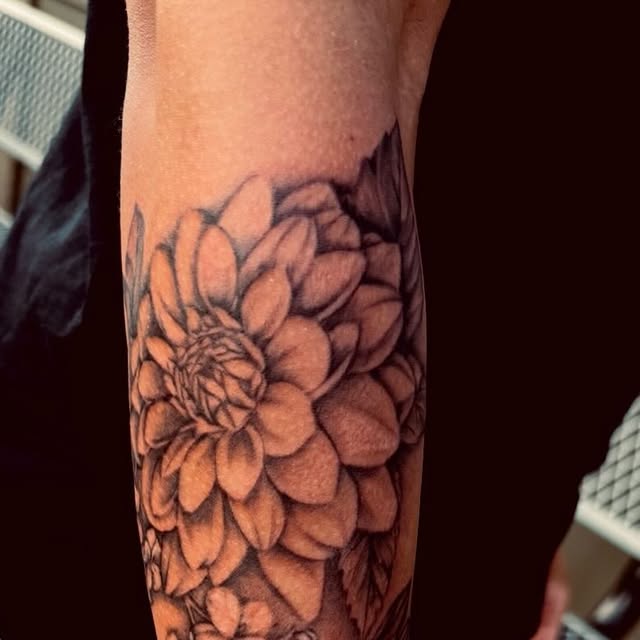 Black and grey dahlia with peach shading on the forearm